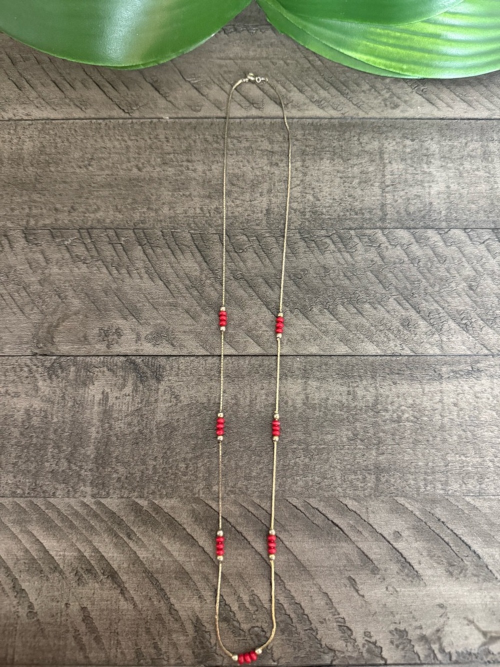 Delicate Gold Strand Necklace with Red Bead Accents